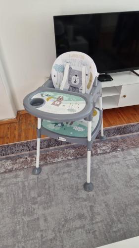 a childs high chair sitting in front of a tv at Erdem Apartment in Atakum