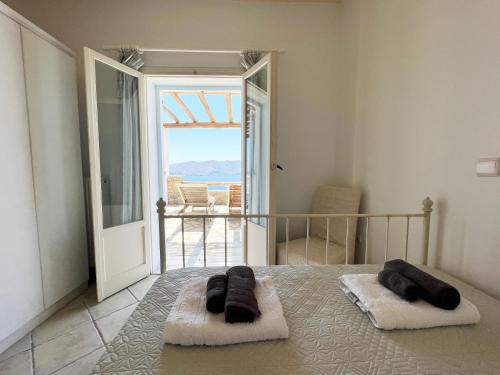 a bedroom with a bed with a view of the ocean at Estia's Residence in Mýkonos City