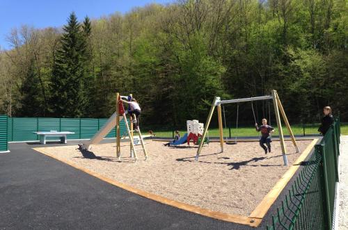 a group of people playing on a playground at Le Rhien Hôtel-Restaurant in Ronchamp