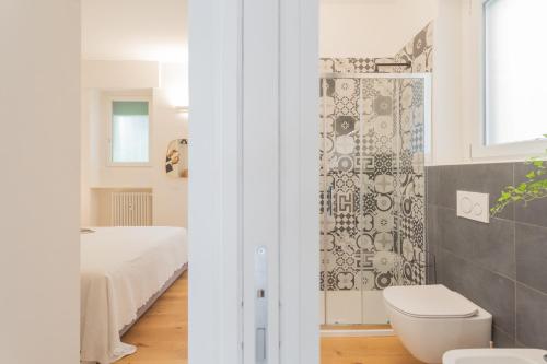 a bathroom with a shower and a toilet in a room at A Step from the Lake Apartment by Rent All Como in Como