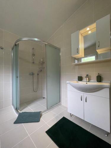 a bathroom with a shower and a sink at Bezirgan Inn Kalkan in Islamlar