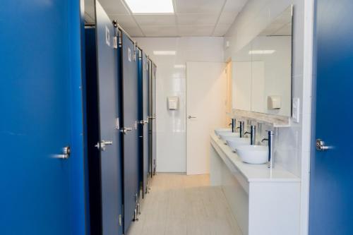 a bathroom with four sinks and a row of toilets at HOSTEL PRIME in Benicàssim