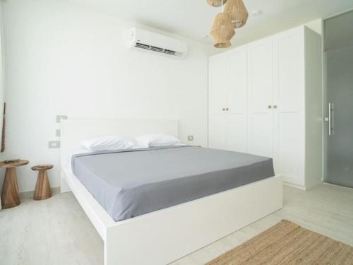 a white bedroom with a large bed in it at Sea view villa in fouka bay with private pool 21B in Marsa Matruh