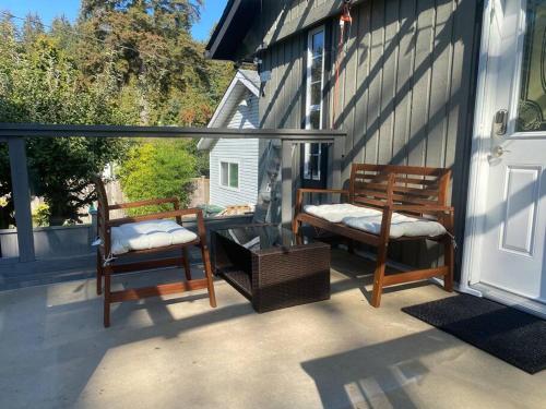 two chairs sitting on a porch with a door at Luxury North Vancouver 3 bedroom Up Level House in North Vancouver
