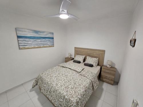 a bedroom with a bed and a painting on the wall at HDA apartment 2. in Torrevieja