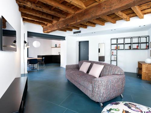 a living room with a couch and a table at SG9 CITY APARTMENTS in Brescia