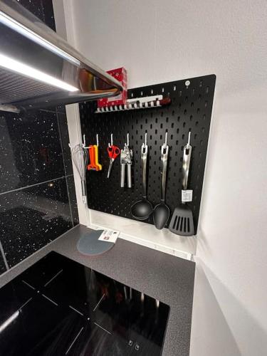 a cupboard filled with utensils in a kitchen at luxurious 2-room apartment in central Borås in Borås