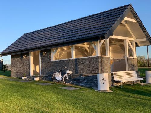 a house with a bike parked in front of it at MAŁY PORT-Iława - Jezioro - Plaża - Marina priv - 5 pokoi VIP - czysto na 10 in Iława