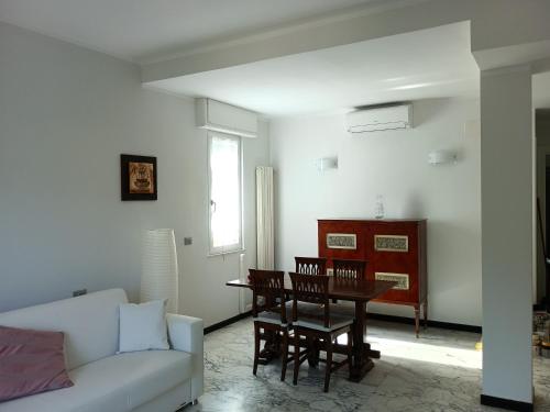 a living room with a table and a couch at Casa Oliveta in Rapallo