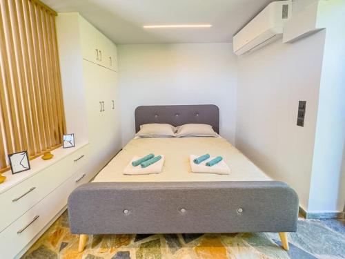 a bedroom with a bed with two pillows on it at Lemon Tree Villa in Chalkida