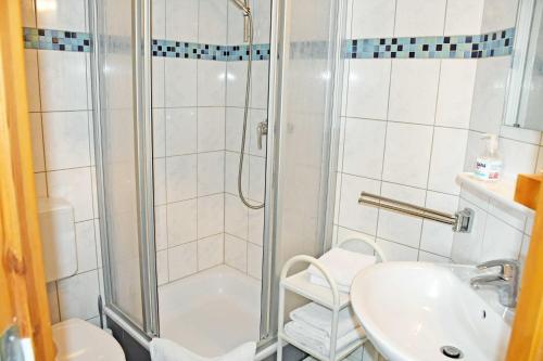 a bathroom with a shower and a sink at Hotel Inselglück in Lohme