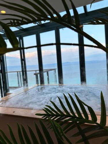 a hot tub with a view of the ocean at Rigas Boutique Hotel & Spa in Afitos