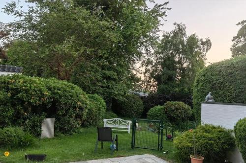 a garden with a bench in the grass at Villa Sonnen-Blick in Aachen