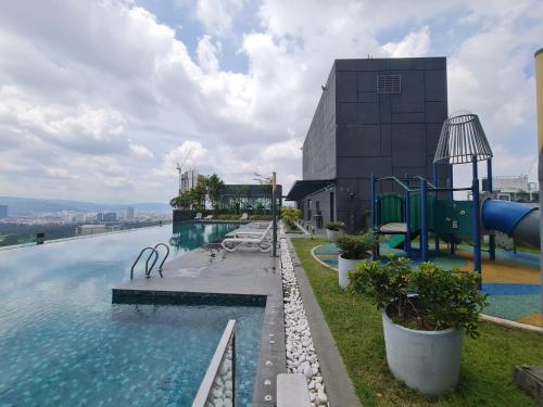a swimming pool on top of a building at Dorsett Bukit Bintang Residence by De Space in Kuala Lumpur