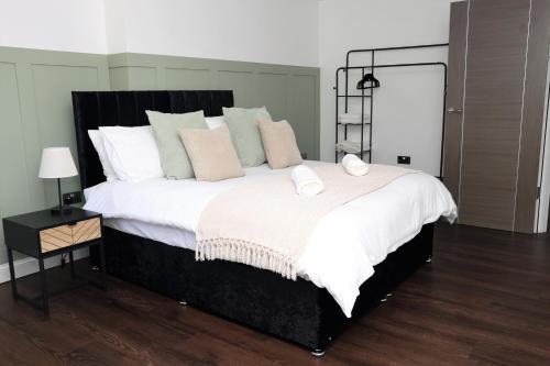 - une chambre dotée d'un grand lit avec des draps et des oreillers blancs dans l'établissement Watford Luxury 1 Bed Flat - Free Parking, à Watford