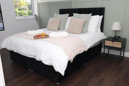 a large bed with a tray of fruit on it at Watford Luxury 1 Bed Flat - Free Parking in Watford