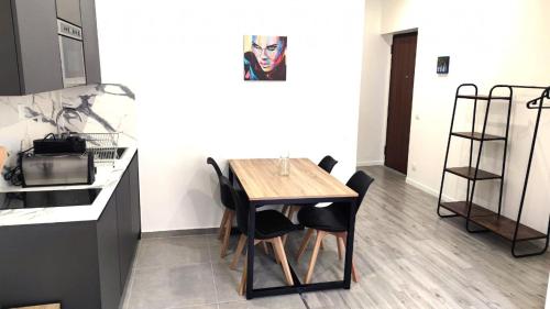 une cuisine avec une table en bois et des chaises noires dans l'établissement Republique centre 31, à Nice