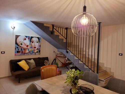 a living room with a couch and a staircase at INDUSTRY HOME in Catania