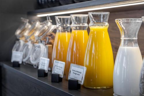 a bunch of bottles of orange juice on a shelf at Intelier Victoria in Donostia-San Sebastián