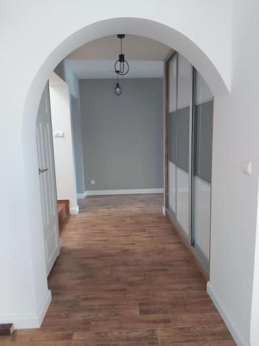 an empty hallway with an archway in a building at Green Hill House in Pępice
