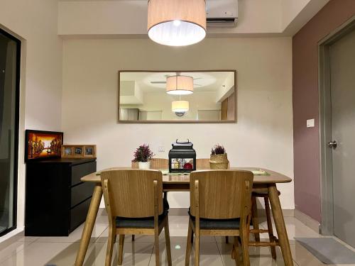 a dining room with a table and two chairs at Cozy Hyve Soho Suites in Cyberjaya