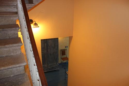 a hallway with a staircase and a mirror on the wall at Hotel Residence Le Chiavi Di San Francesco in Trapani