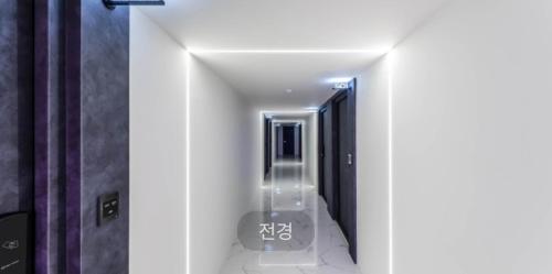 a hallway of a bathroom with a walk in shower at Hotel Sono in Incheon