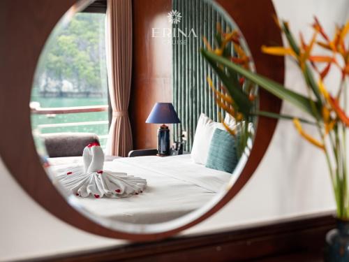 a hotel room with a bed and a mirror at Erina Cruise by HAG in Ha Long