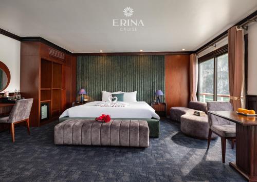 a hotel room with a bed and a desk and chairs at Erina Cruise by HAG in Ha Long
