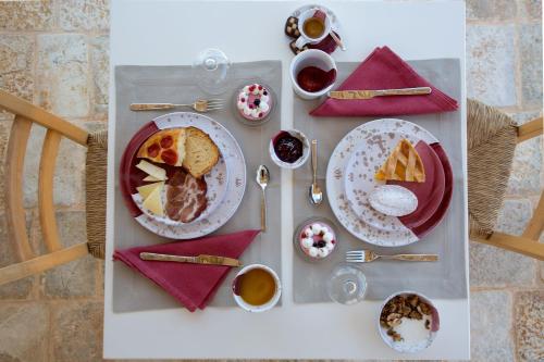 a table with plates of food and drinks on it at Ddò Relais di Puglia in Ostuni