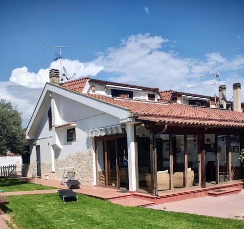 a house with a porch with a roof at Villa Mery in LʼAmericano