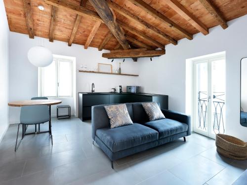 a living room with a blue couch and a table at SG9 CITY APARTMENTS in Brescia