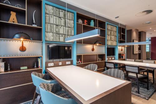 a dining room with a white table and chairs at Premier Inn Leipzig City Oper in Leipzig