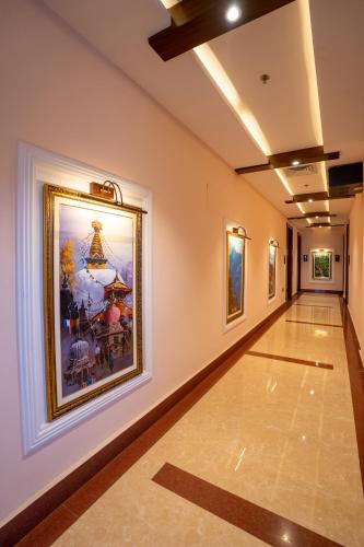 an empty hallway with paintings on the walls at Dream International Hotel in Lumbini