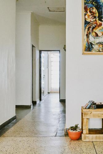 an empty hallway with a table and a painting on the wall at Karibu Africa Home in Moshi