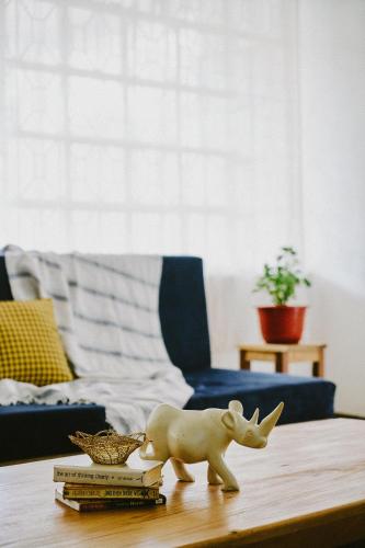 a toy bear sitting on top of books on a table at Karibu Africa Home in Moshi