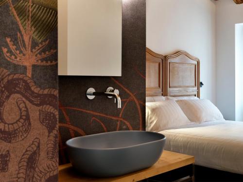 a bathroom with a bath tub next to a bed at SG9 CITY APARTMENTS in Brescia