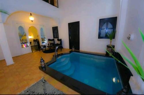 a large swimming pool in a living room at Riad Des ours in Marrakesh