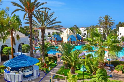 an aerial view of a resort with palm trees and a pool at Caribbean Village Agador - All inclusive in Agadir