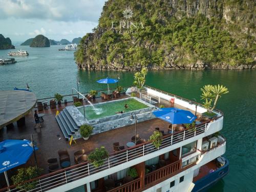 a cruise ship in the water with tables and umbrellas at Erina Cruise by HAG in Ha Long