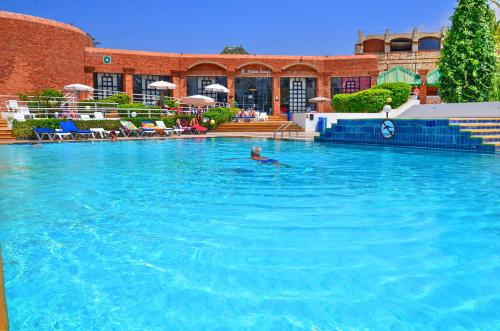 a person swimming in a large swimming pool at Caribbean Village Agador - All inclusive in Agadir