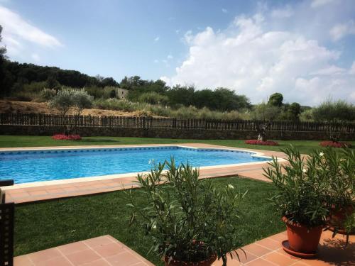 a swimming pool in a yard with plants at Sa Boadella - Fenals Beach in Lloret de Mar