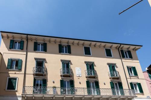 a large building with balconies on a street at Palazzo Betteloni in Bardolino
