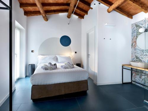 a bedroom with a white bed with a blue floor at SG9 CITY APARTMENTS in Brescia