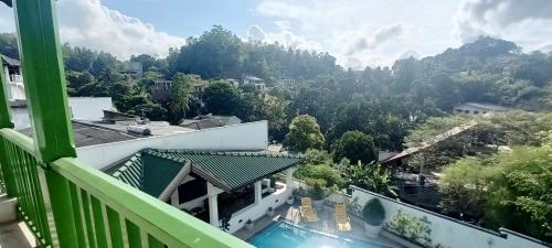 a view from the balcony of a house with a swimming pool at Kaya Residence Kandy in Kandy
