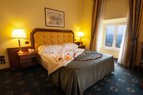 a hotel room with a bed and a window at Hotel San Giorgio in Civitavecchia