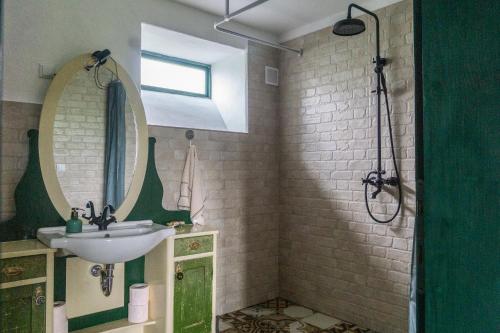 a bathroom with a sink and a mirror at Hillside View Cottage - Csíksomlyó-panoráma vendégház in Păuleni-Ciuc