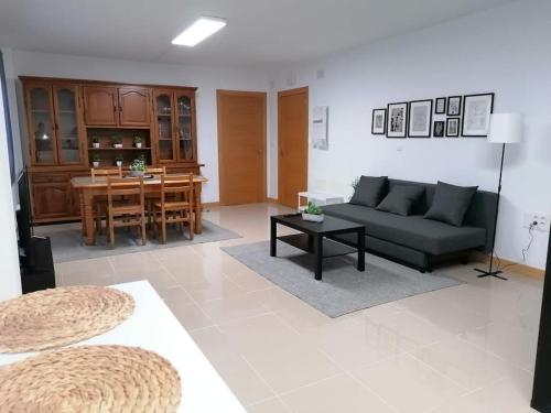 a living room with a couch and a table at Lar de Yago - Apto in Ribadeo