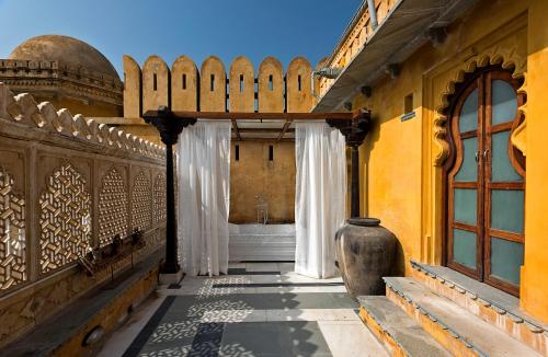 a hallway of a building with a window at Gogunda Palace in Udaipur
