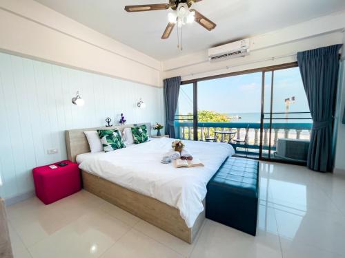a bedroom with a large bed with a view of the ocean at MANDARIN LODGE by victor in Hua Hin